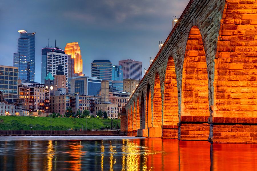 The Stone Arch Bridge and Minneapolis skyline at dusk
